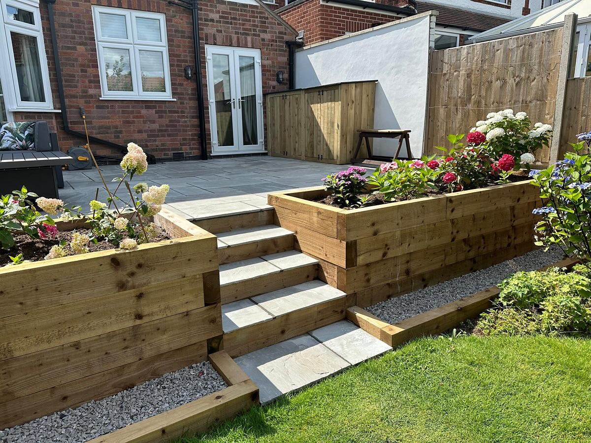 Timber sleeper raised planters and porcelain steps from patio side — Birstall