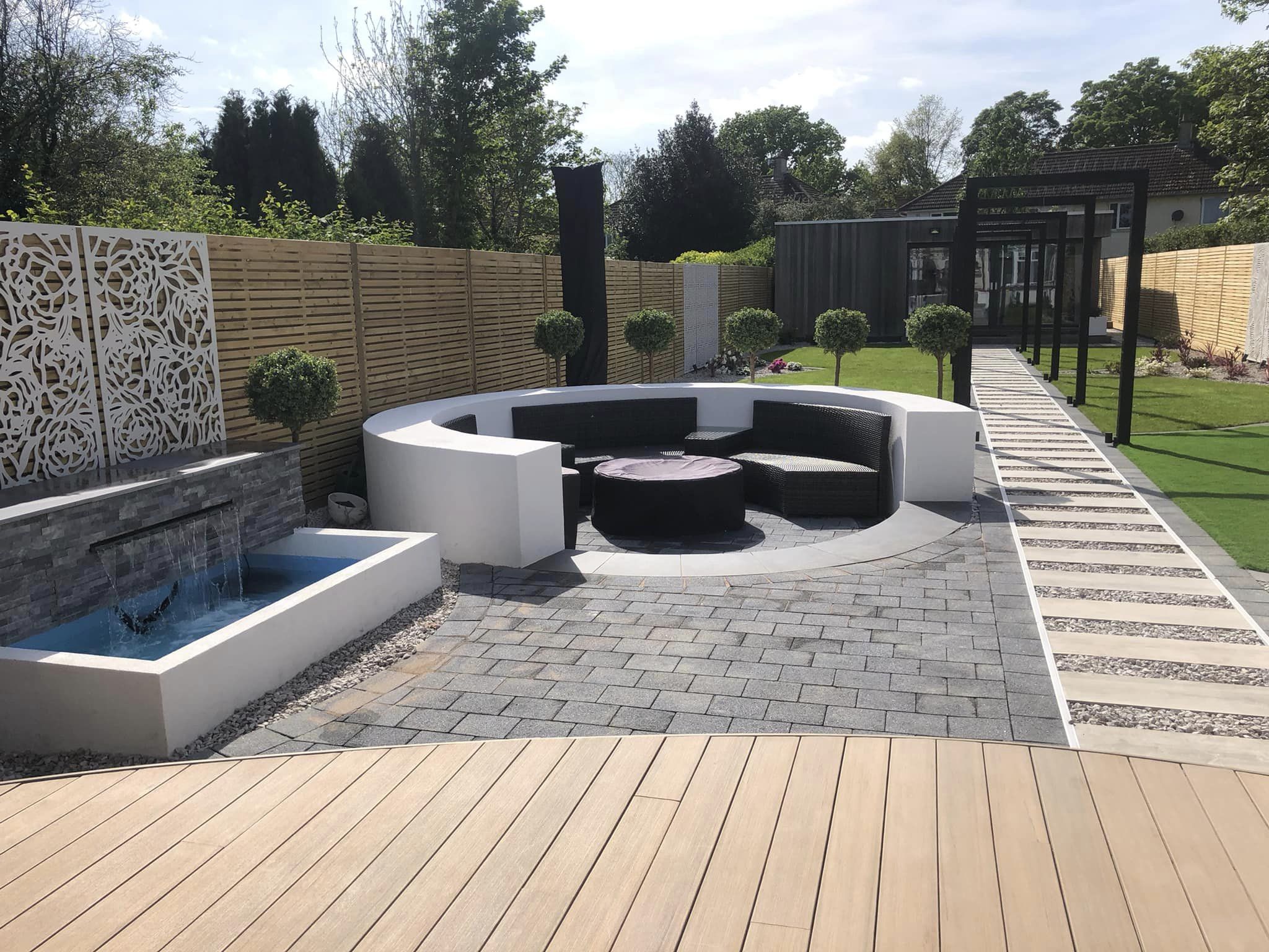 View from decking showing water feature, fire pit seating area and pergola walkway, Evington