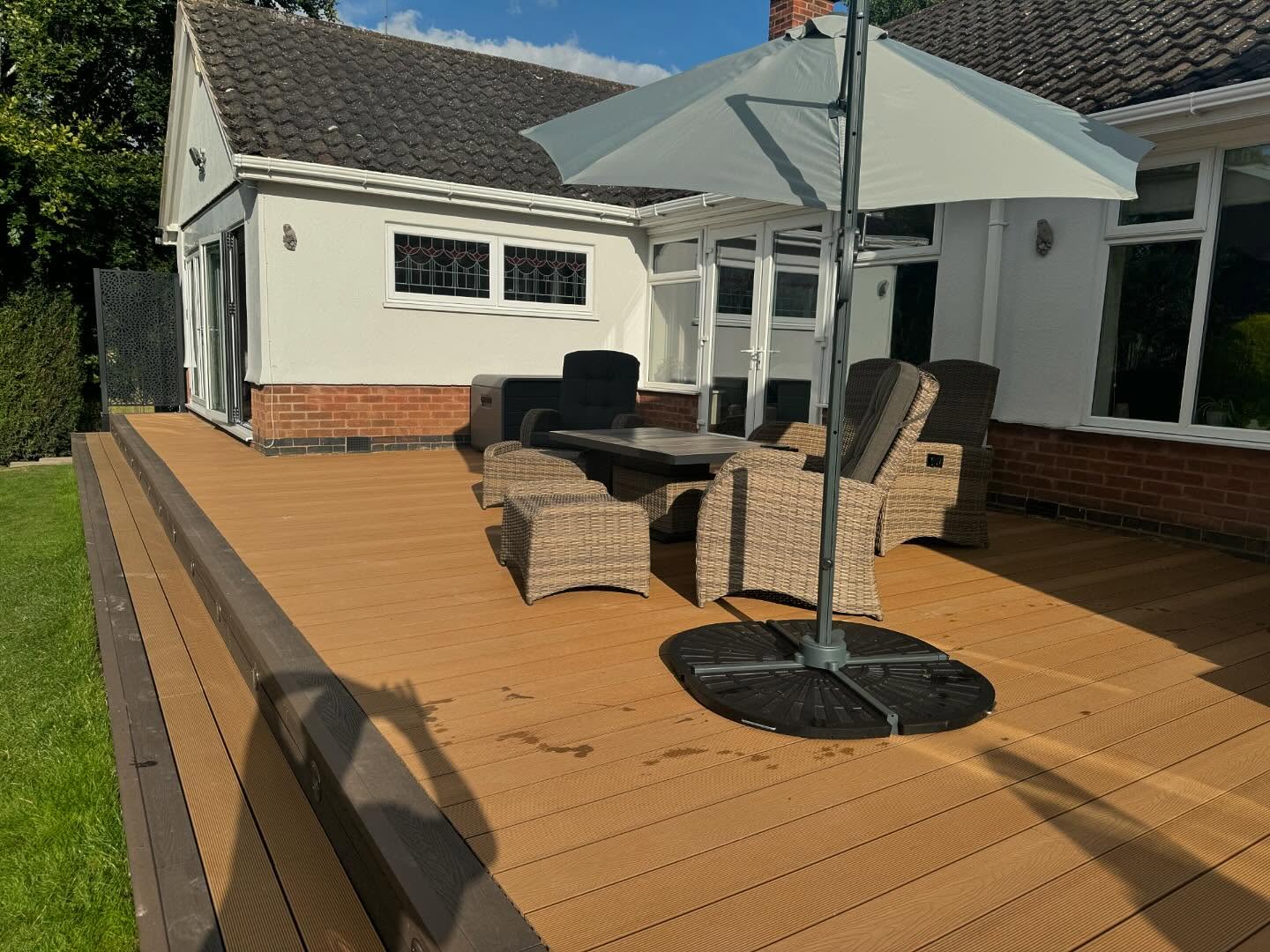 Angled view of deck with furniture and bungalow backdrop — Kirby Muxloe