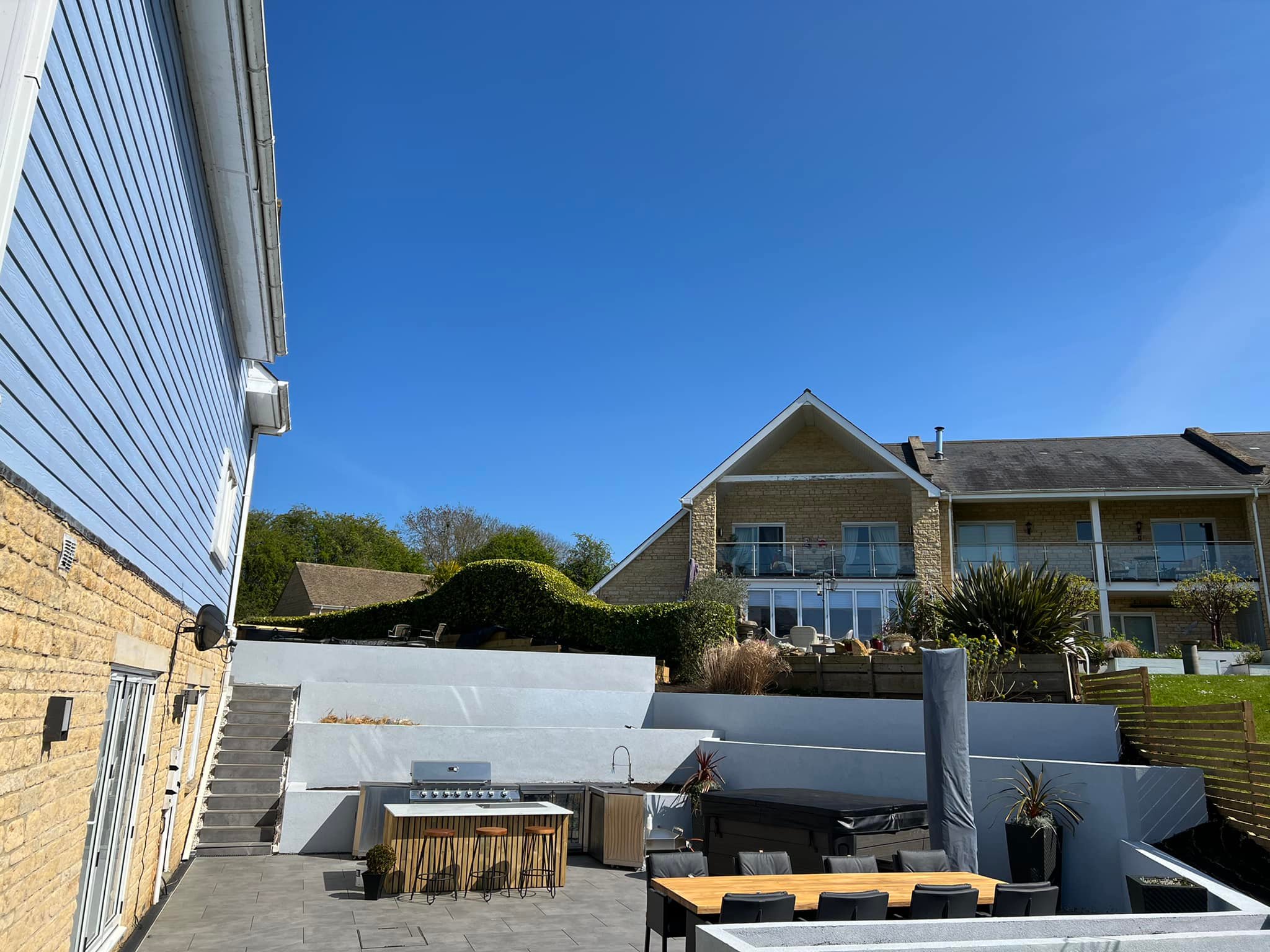 Side elevation showing tiered retaining walls and stair access from house, Peterborough