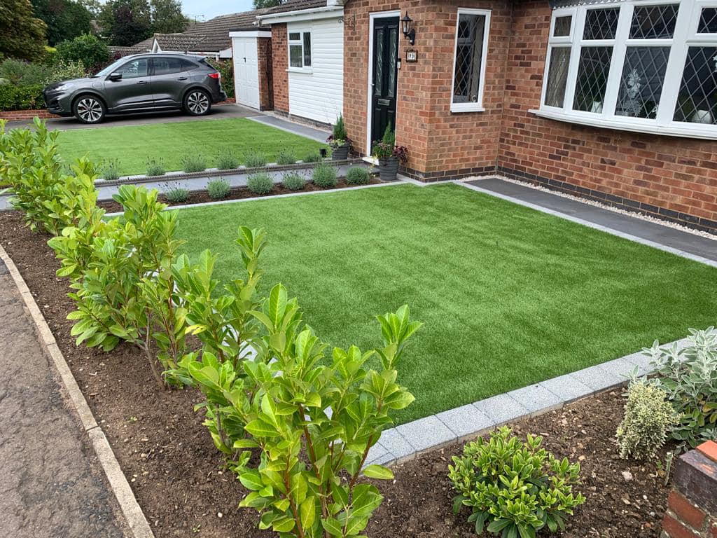 Artificial grass lawn with magnolia hedge and lavender border — close-up, Wigston